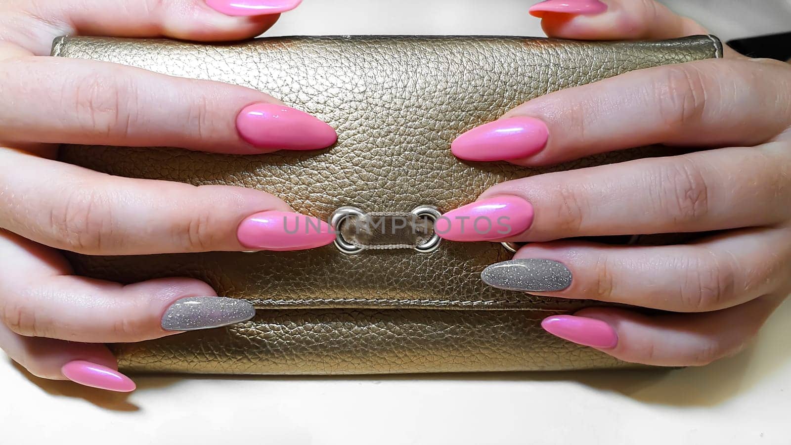 Acrylic nail extension, manicure, nail correction, hands in the foreground. Bright design. copy space