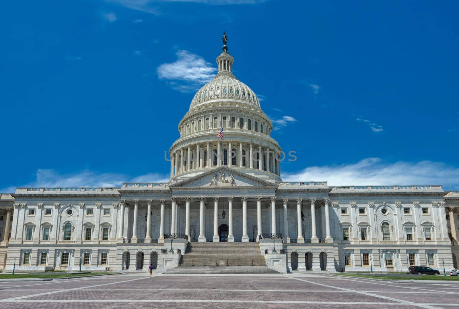 Washington Capitol on sunny cloudy sky background by AndreaIzzotti