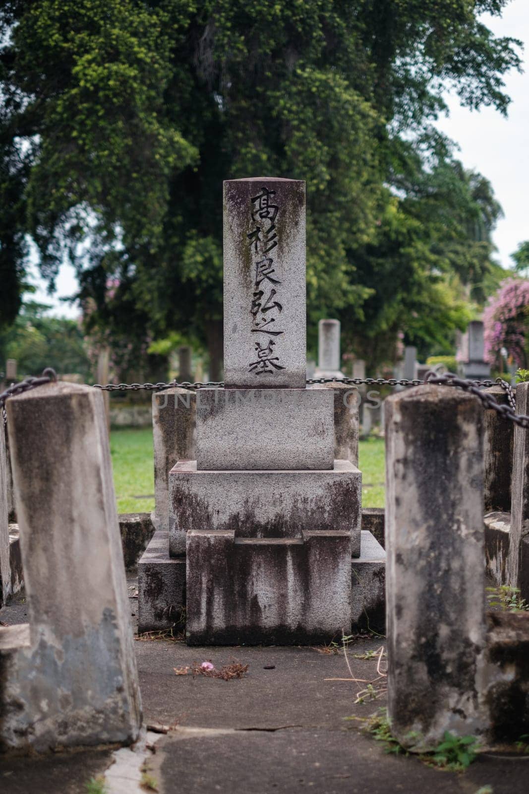 Singapore - July 9 2023: Japanese Tombstone with Stone and Chain Fence