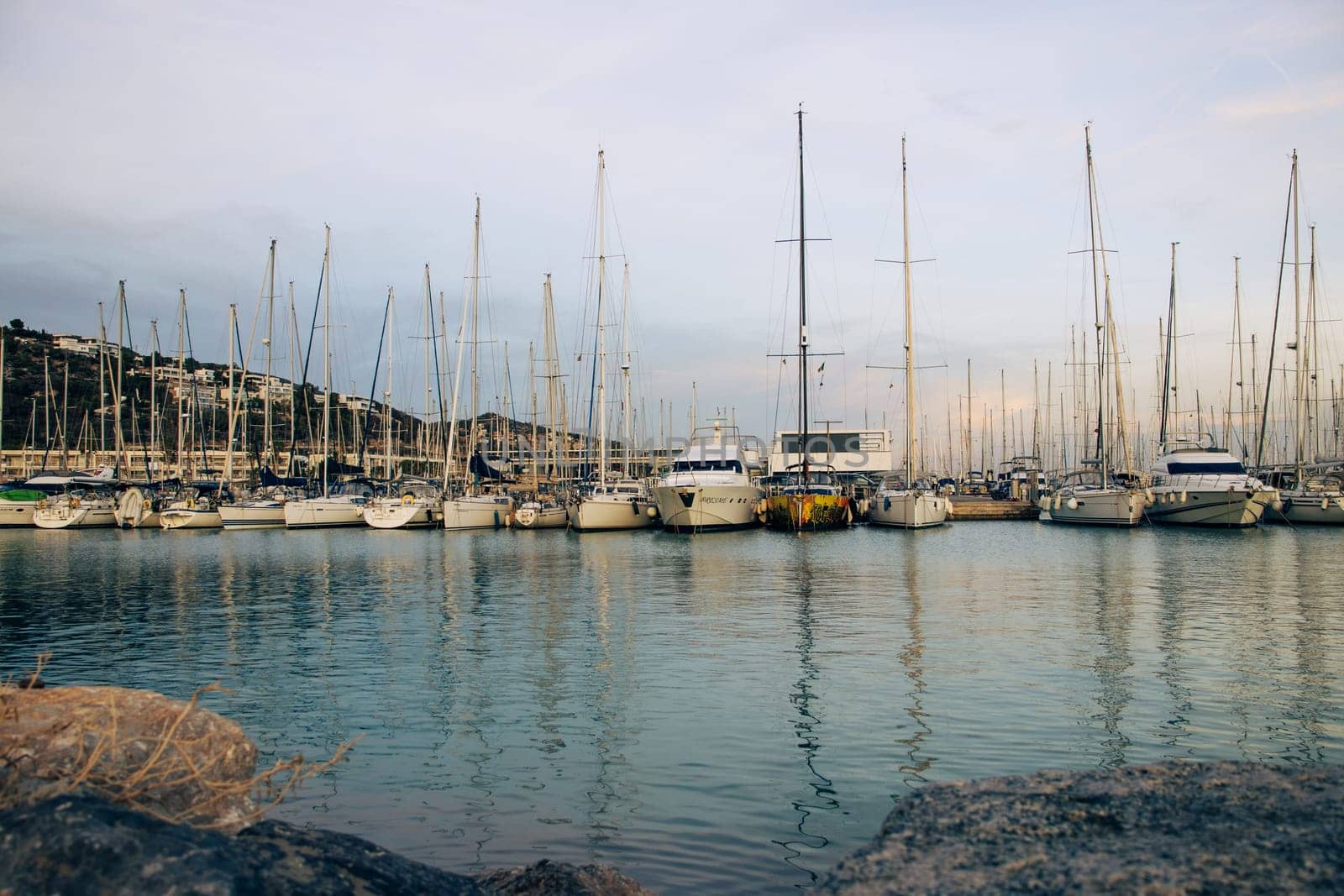 Yachts in the port, sailboats modern water transport. Beautiful moored sail yachts in the sea, modern water by _Nataly_Nati_