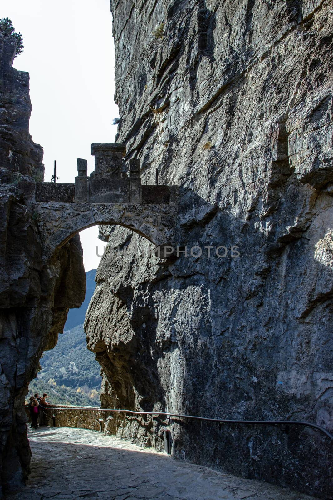 Sant Miquel del Fai Benedictine mountain monastery. Monastery entrance set in cliffs, Catalonia. Beautiful mountain view of hills grade in the morning photography. Miravet town