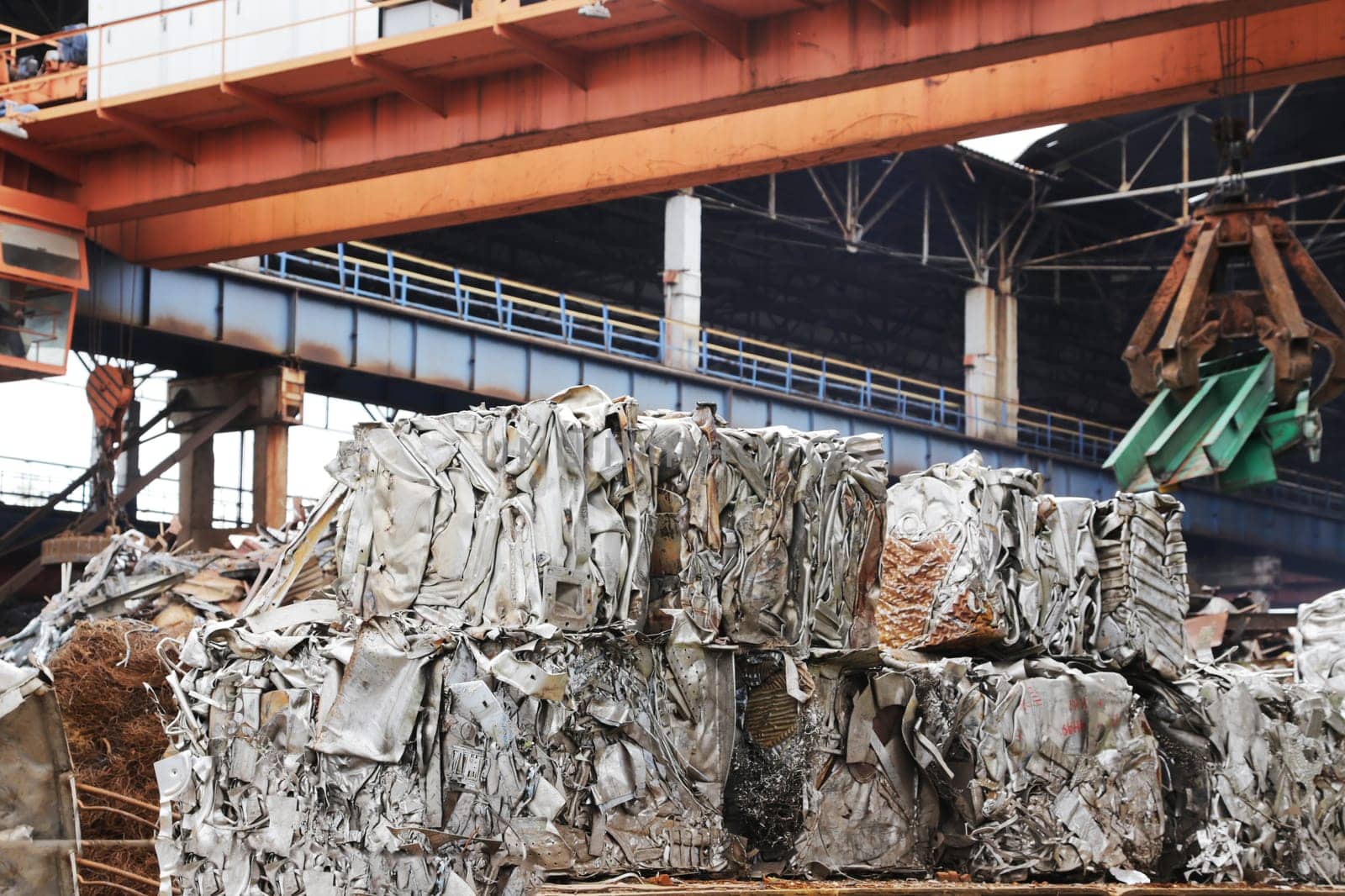 Scrap yard, pressing non-ferrous scrap metal into a cube. Recycling of metal waste.