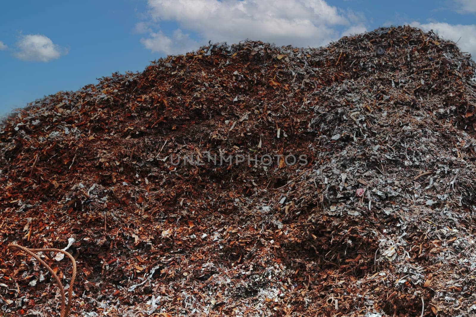 A large pile of rusty metal waste against the sky. by gelog67