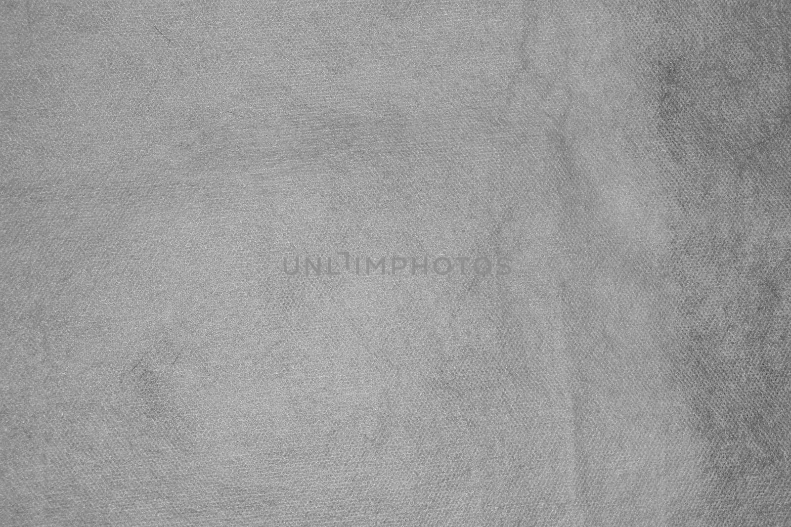 Texture of non-woven material in gray. Background for copy spaced designs.