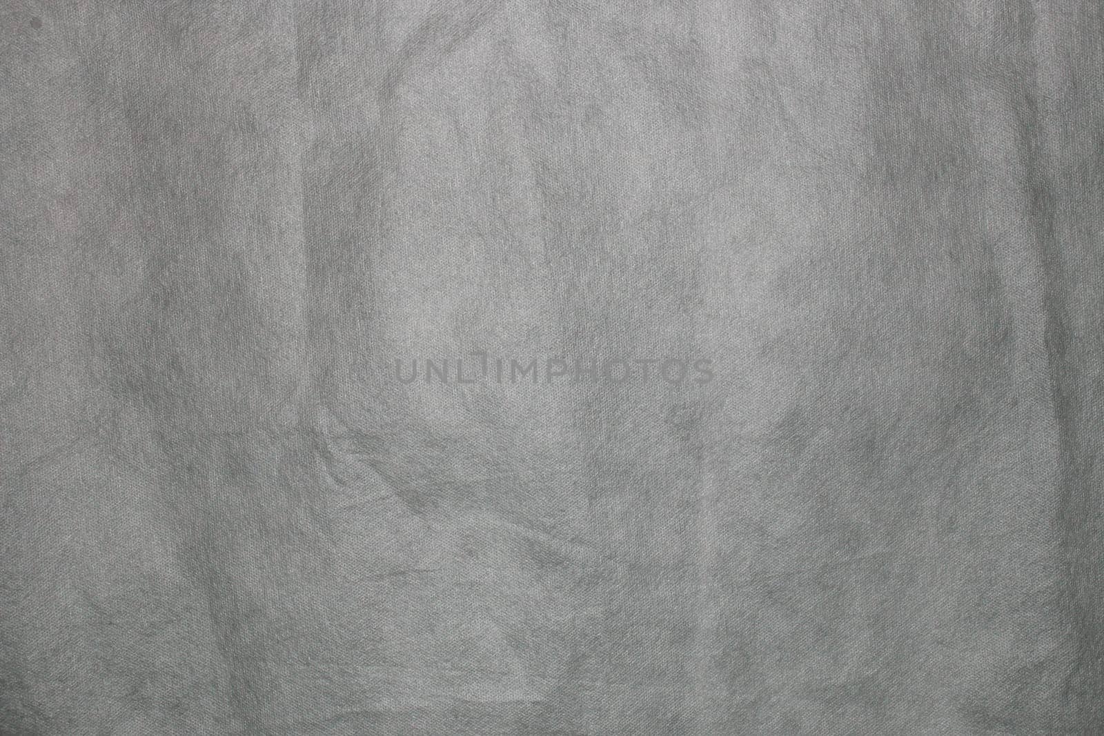 Defocus grey spunbond non-woven geotextile close-up macro. by gelog67