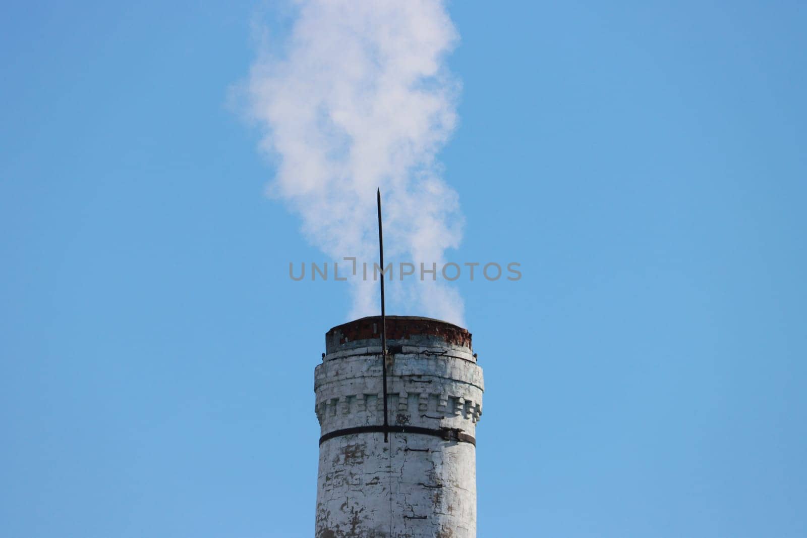 Old chimney with smoke against the sky. by gelog67