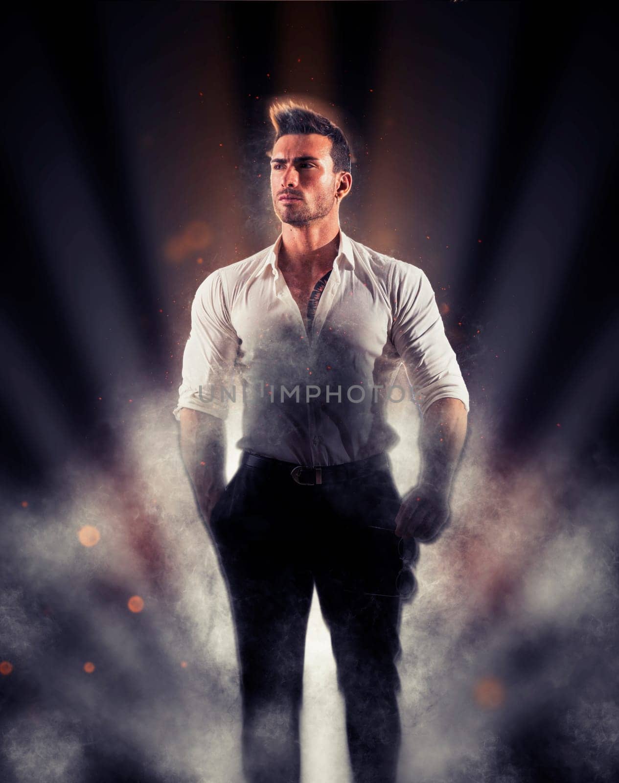 Photo of a confident man posing in front of a spotlight with a casual stance by artofphoto