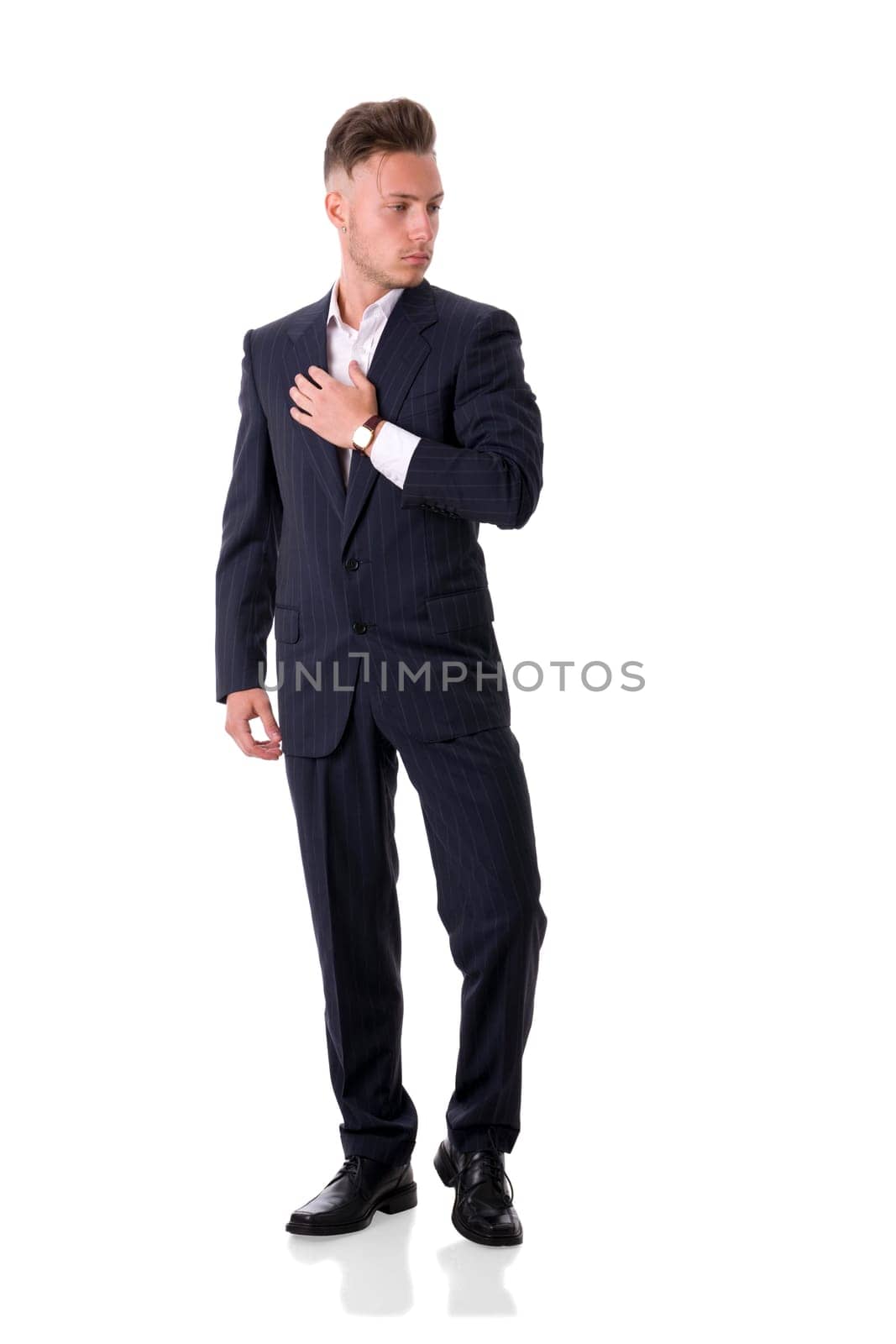 A man in a suit and tie posing for a picture, full figure shot, isolated on white in studio