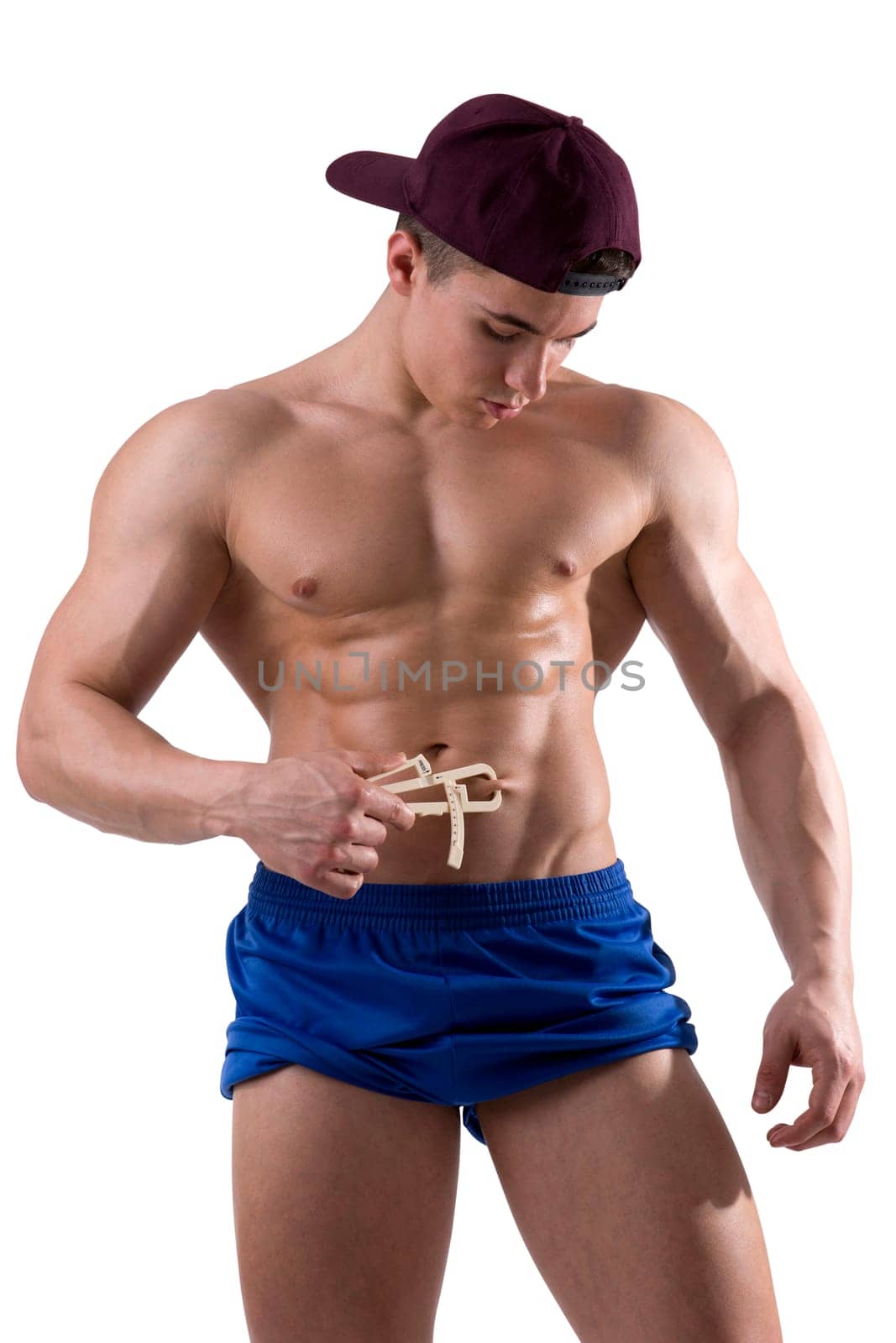 Photo of a shirtless man using a caliper by artofphoto