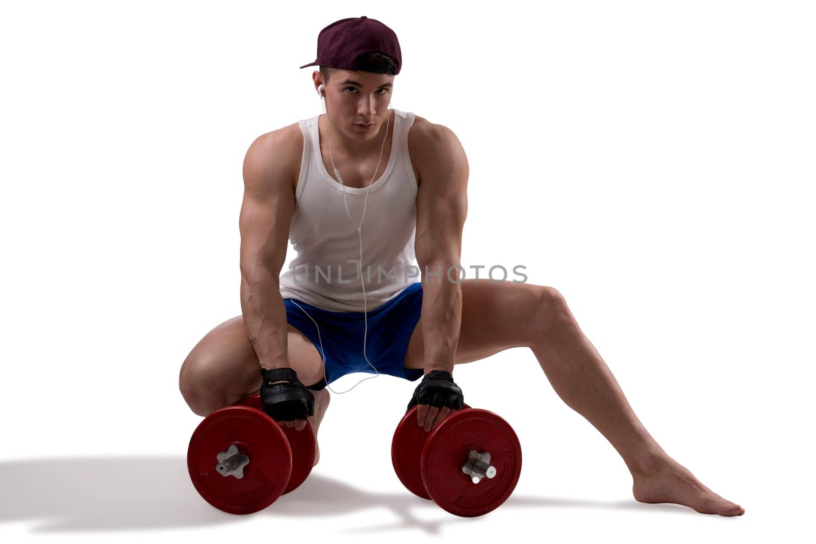 Handsome muscular shirtless young man with dumbbells by artofphoto