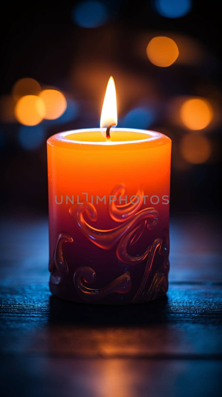 A lit decorated candle with a flame against blue background with defocused lights by chrisroll