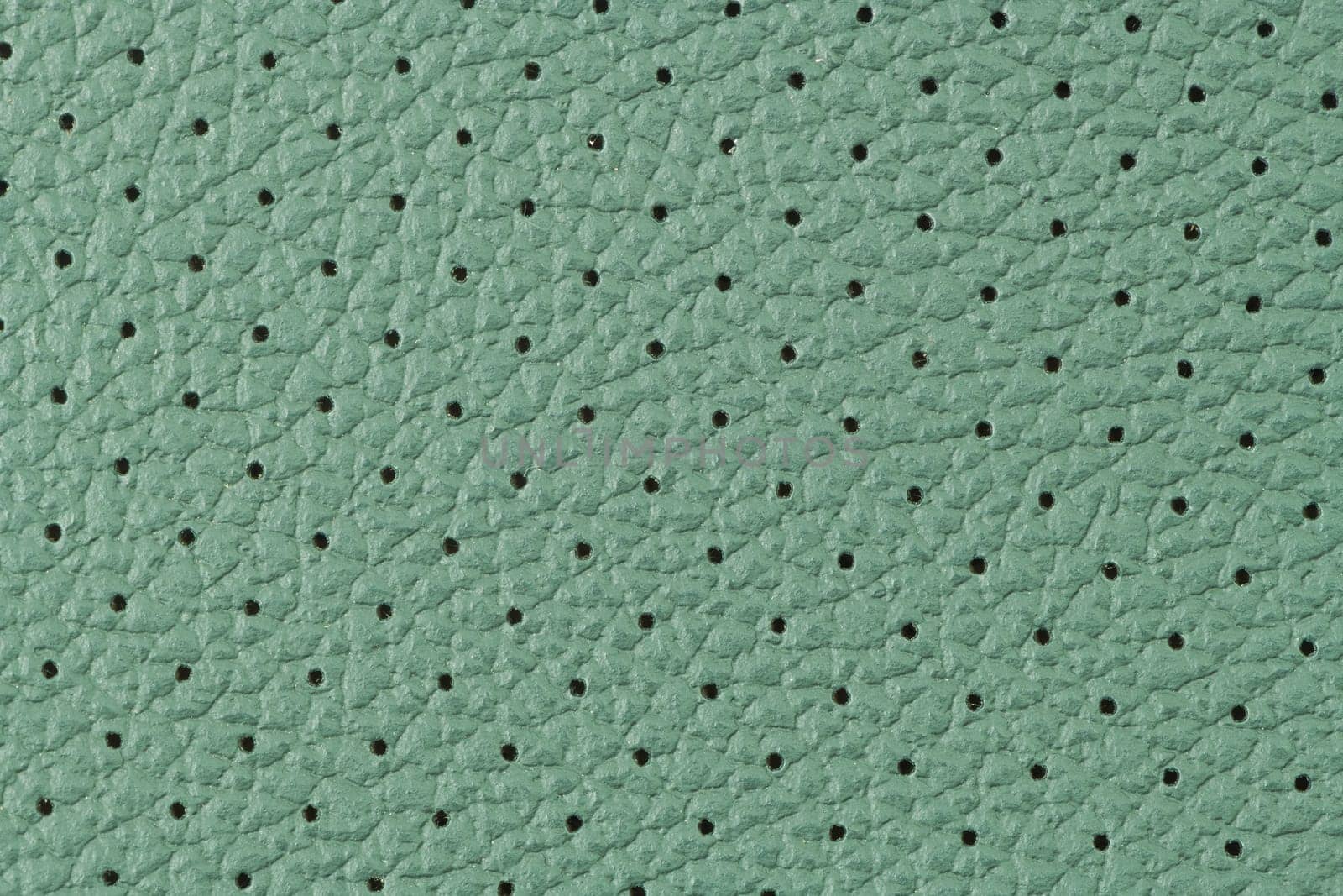 Closeup detail of green leather texture background.