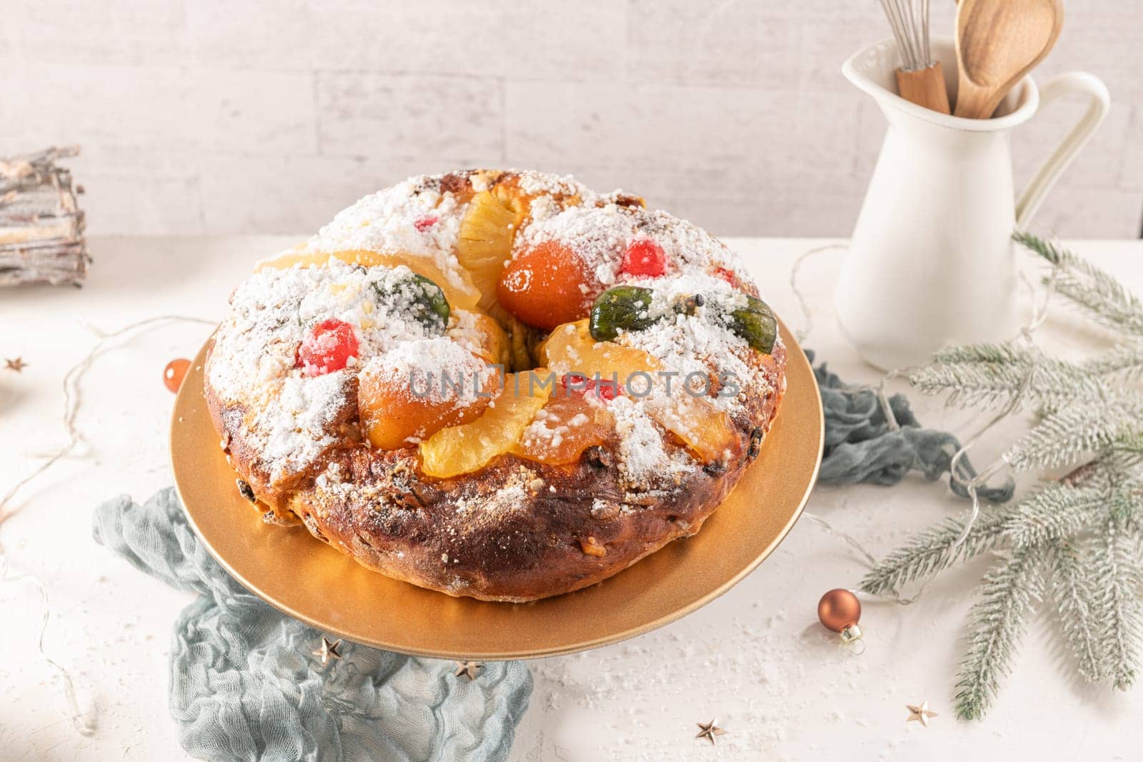 Bolo do Rei or King's Cake, Made for Christmas, Carnavale or Mardi Gras with Christmas season elements in Background.