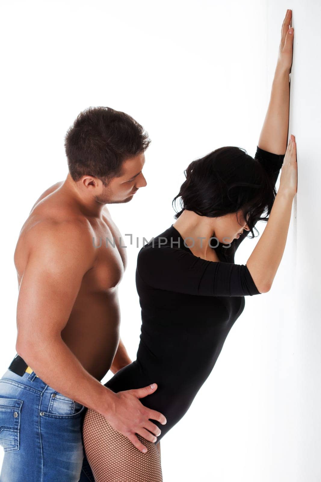 Image of muscular man with bare-chested hugs sexy girl