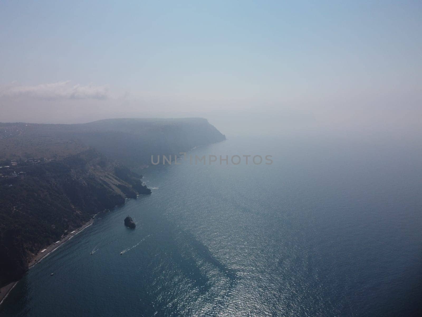 Aerial panoramic view of beautiful sunset above sea. Beautiful seascape. Sun glare, small waves on the water surface. Evening. Horizon. Nobody. No people. Copy space. Never-ending beauty of nature