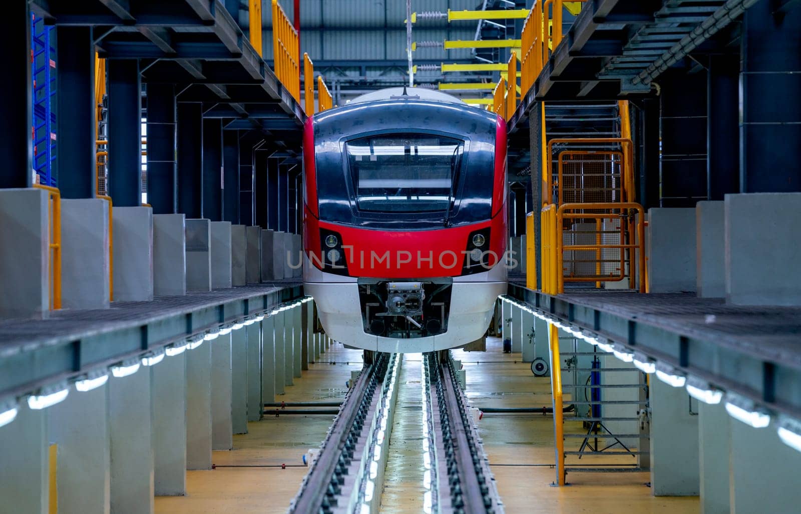 Front of electrical or metro train in the factory workplace with no people during wait to check and maintenance from professional team.