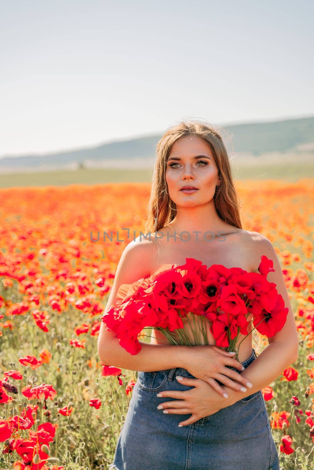 Woman poppies field. portrait happy woman with long hair in a poppy field and enjoying the beauty of nature in a warm summer day. by Matiunina