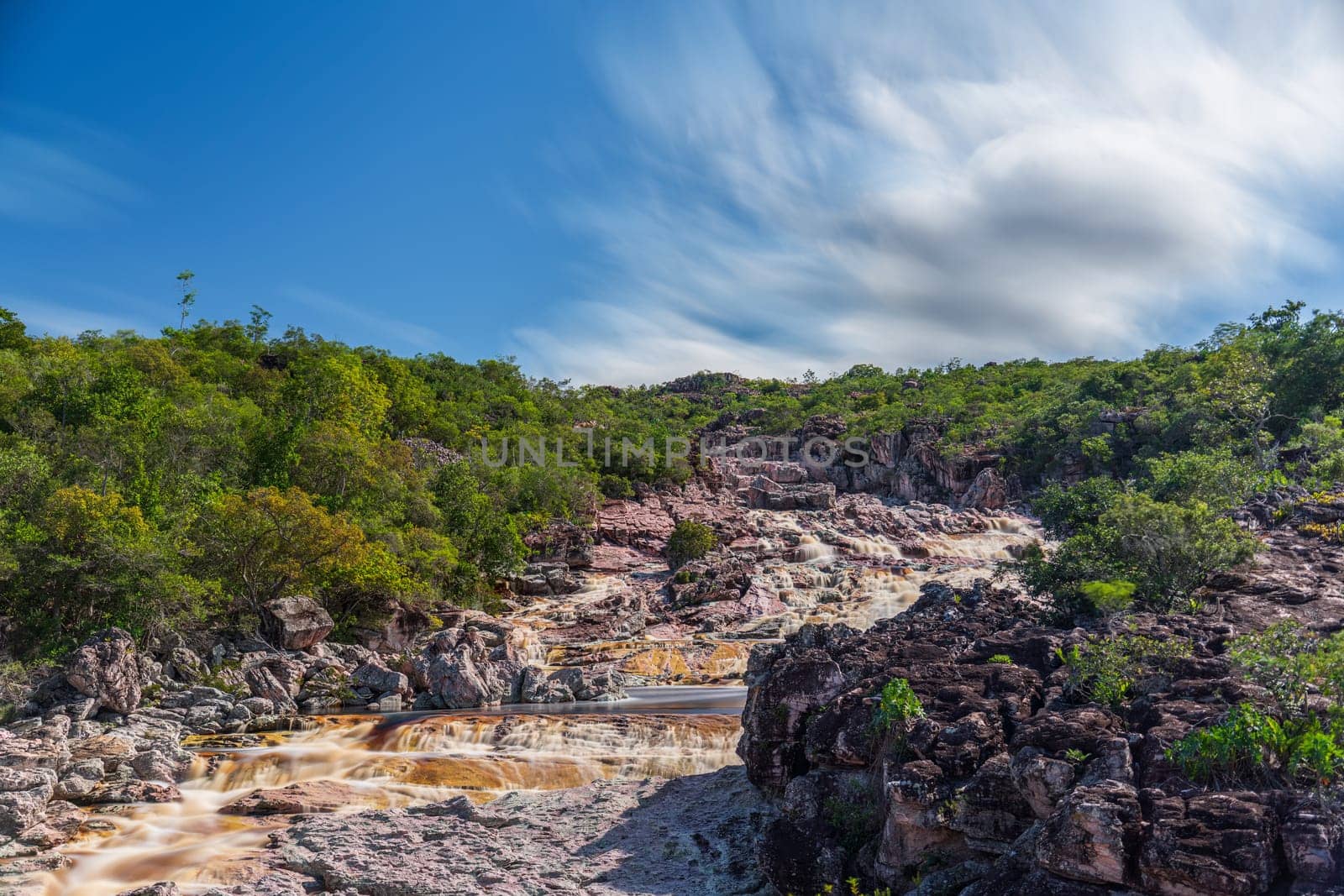 Serene long exposure shot of Roncador River in Chapada Diamantina with silky water and moving clouds. Perfect for nature lovers. Space for text.