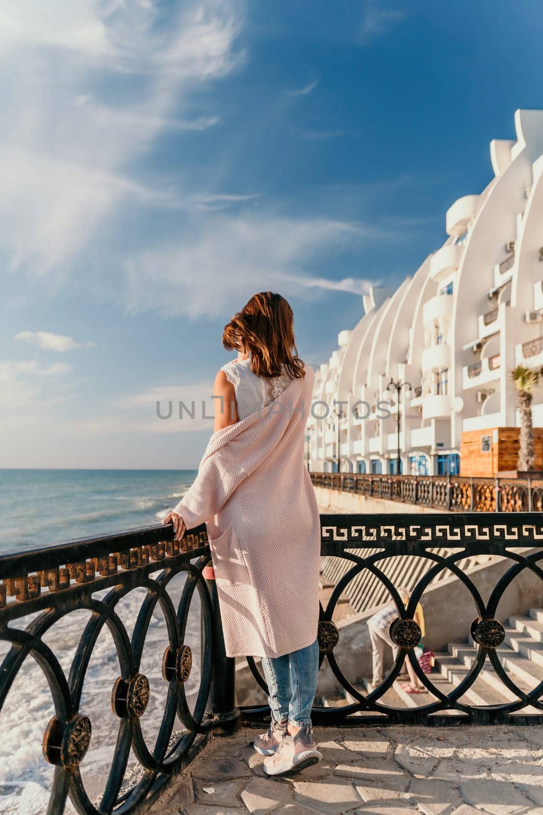 Woman summer travel sea. Happy tourist enjoy taking picture outdoors for memories. Carefree woman traveler posing on beach at sea on sunset, sharing travel adventure journey. Holiday vacation concept. by panophotograph