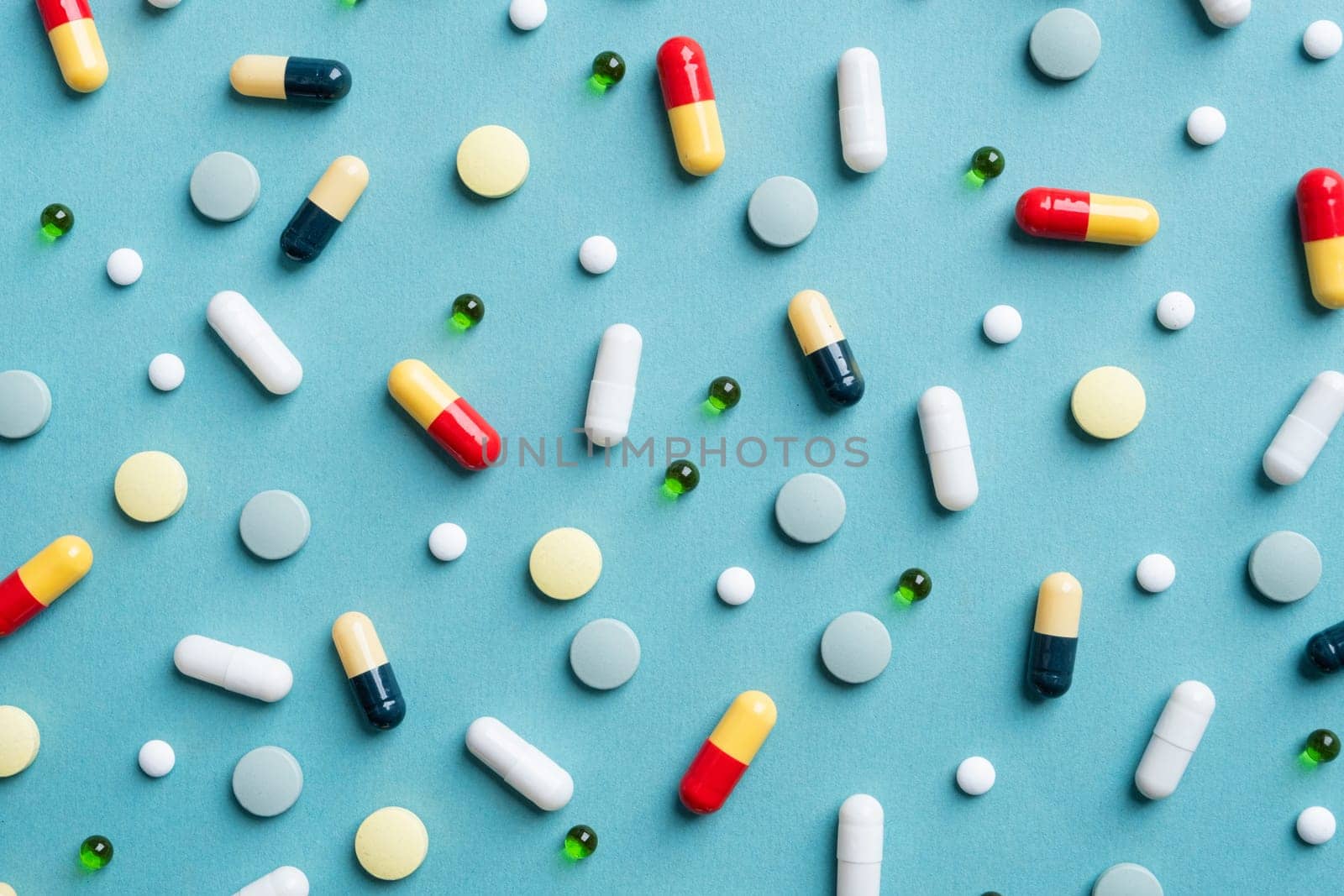 Different pills on color blue background, flat lay