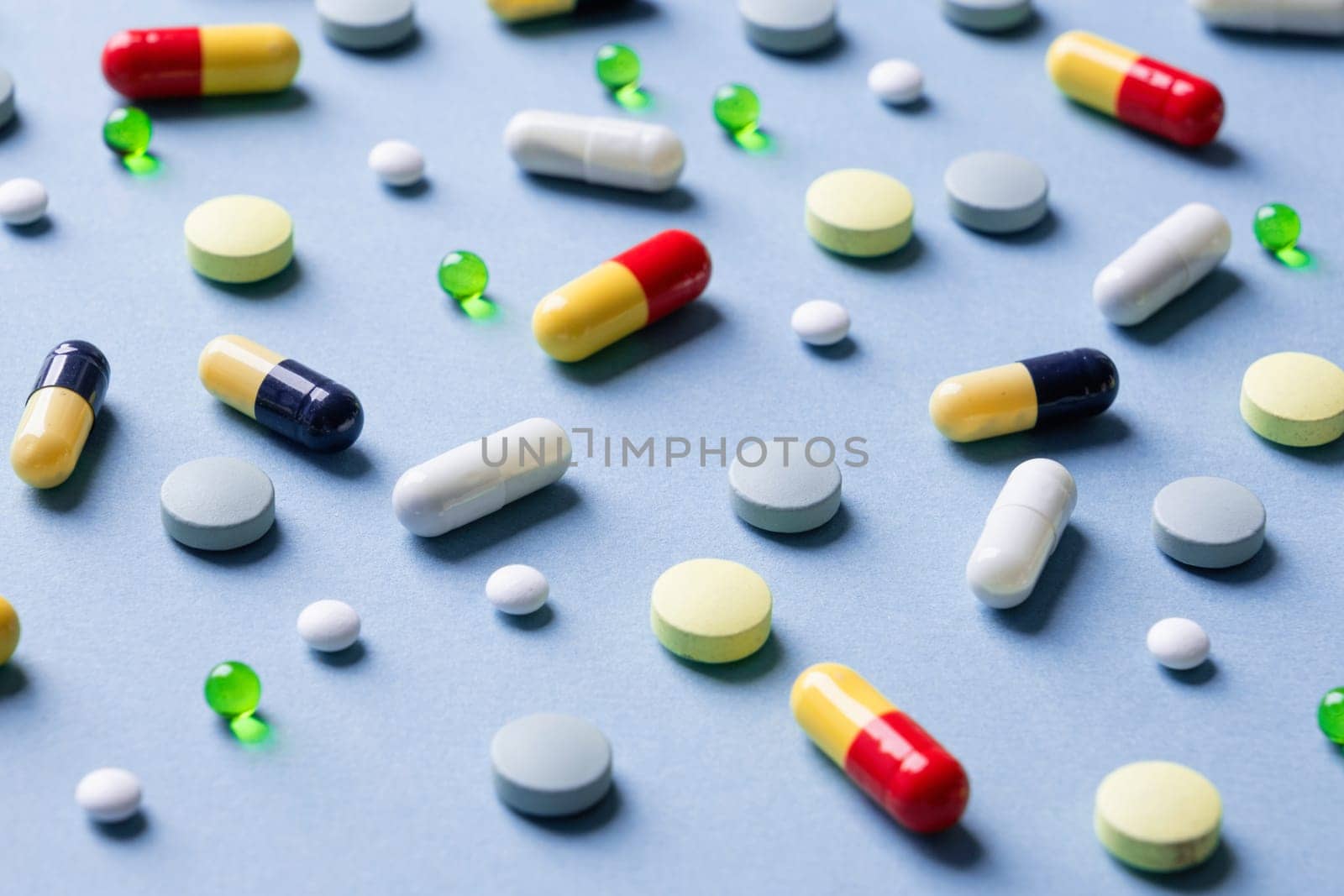 Different pills on color blue background, flat lay