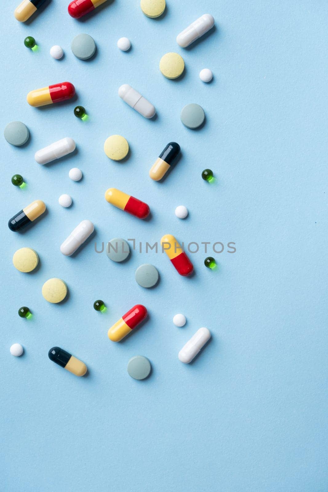 Different pills on color blue background, flat lay