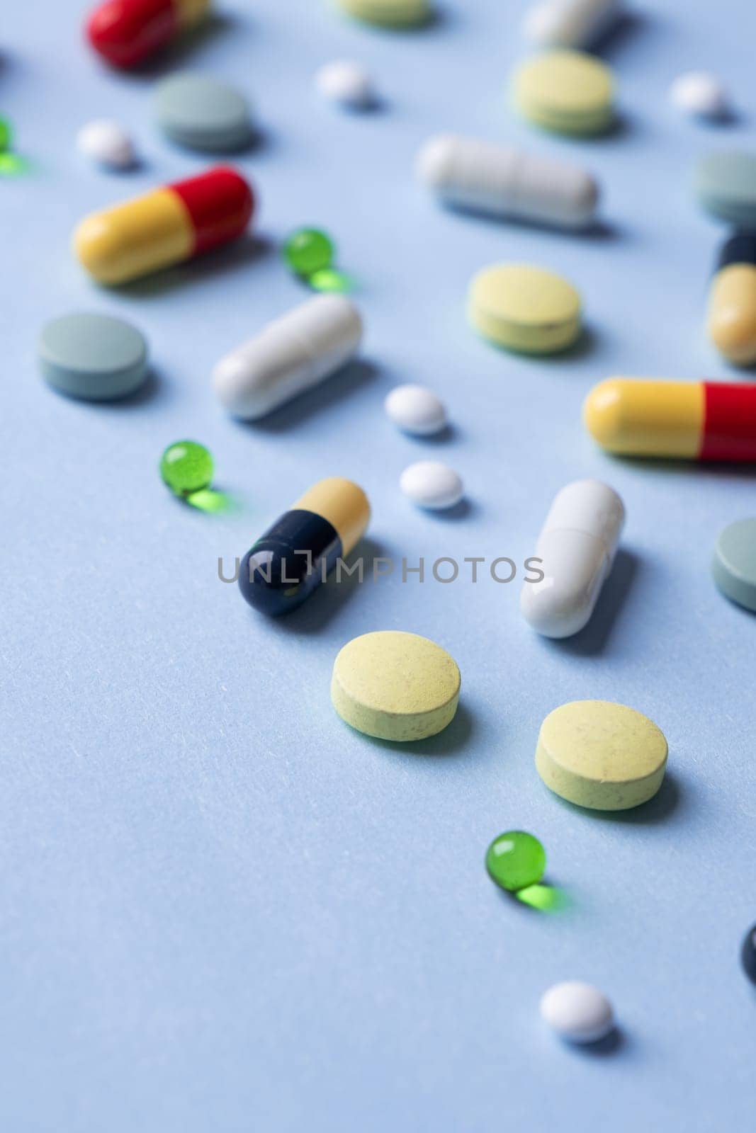 Different pills on color blue background, flat lay