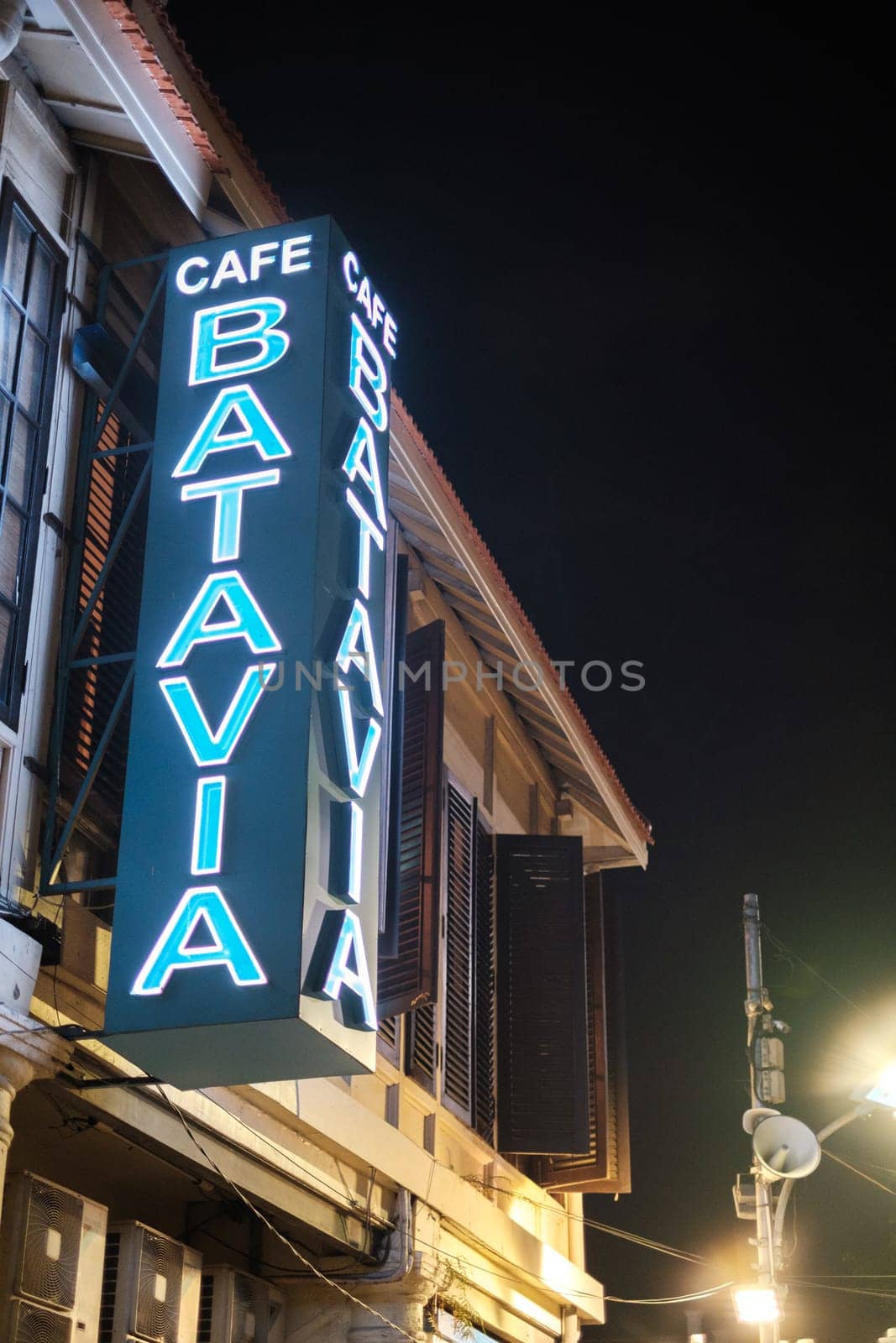 Jakarta, Indonesia - October 2 2023: Cafe Batavia Signboard Light Up at Night by jinhongljh
