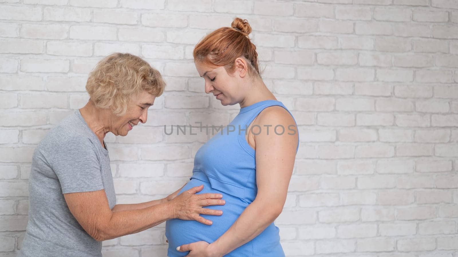 Elderly woman and her adult pregnant daughter. by mrwed54