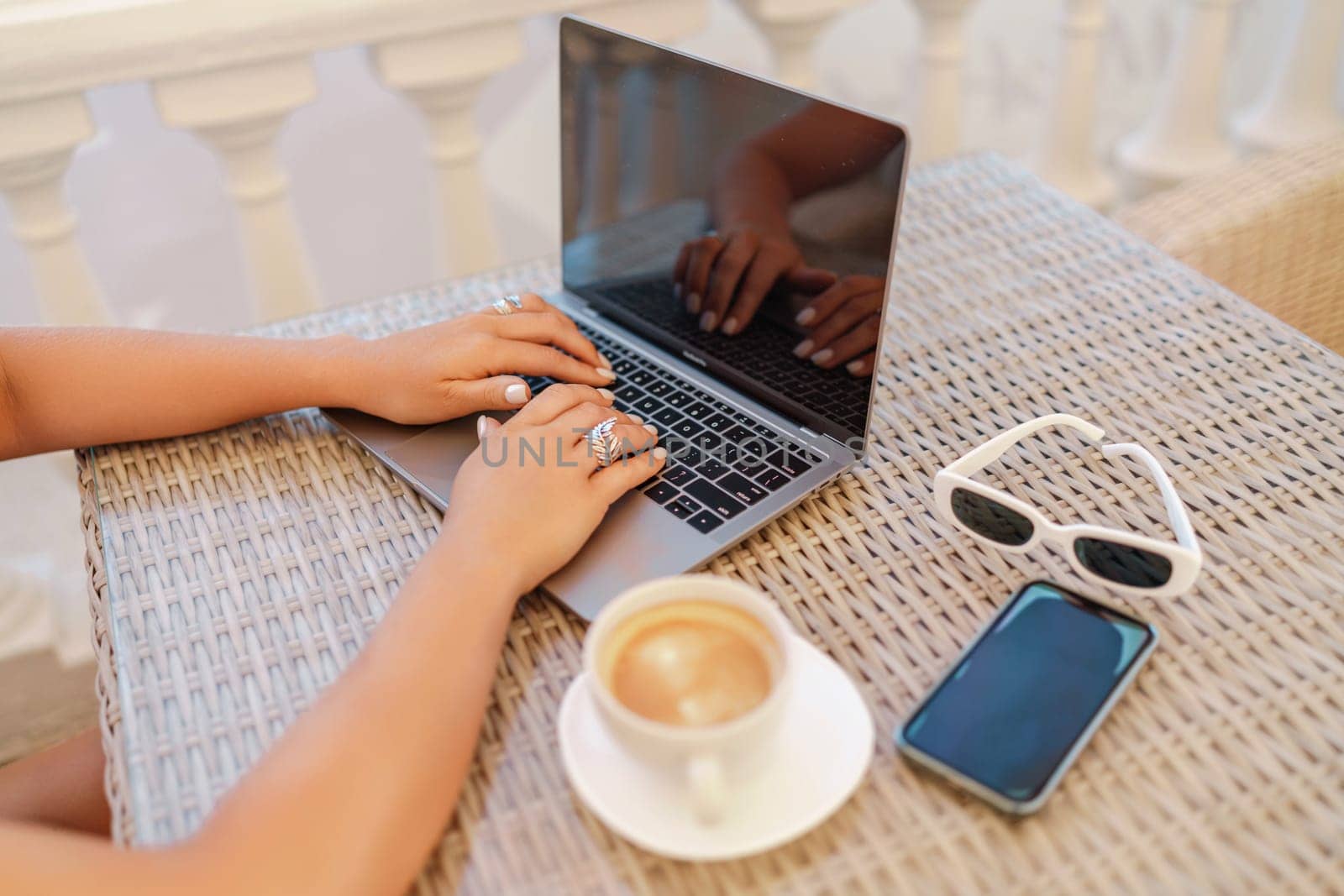 Woman coffee cafe laptop sea. Modern businessman in white uniform working on laptop in coffee shop. Woman sitting at a coffee shop with mobile phone drinking coffee and looking away