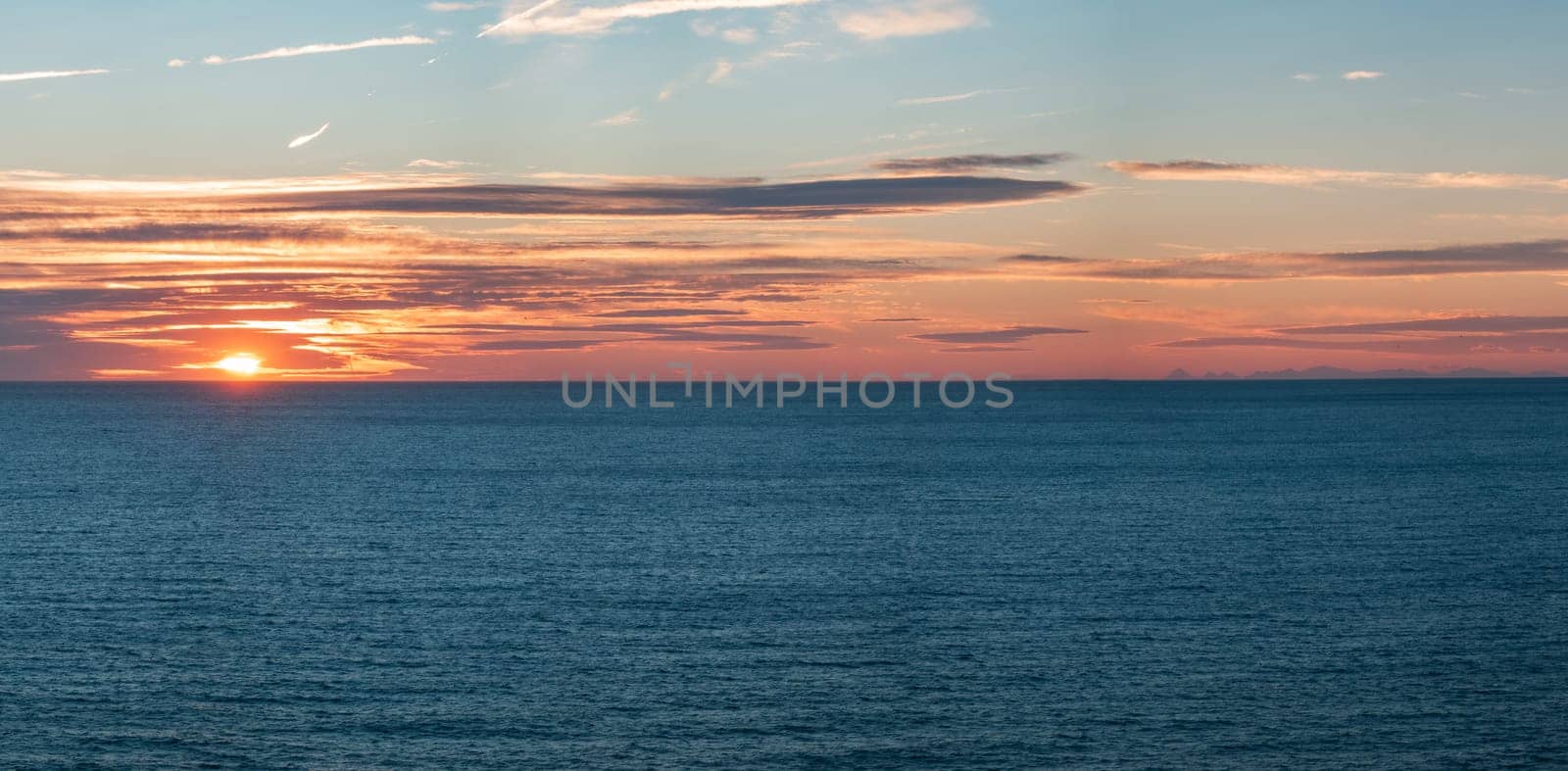 Tranquil Ocean Sunset with Clouds and Distant Islands View by FerradalFCG