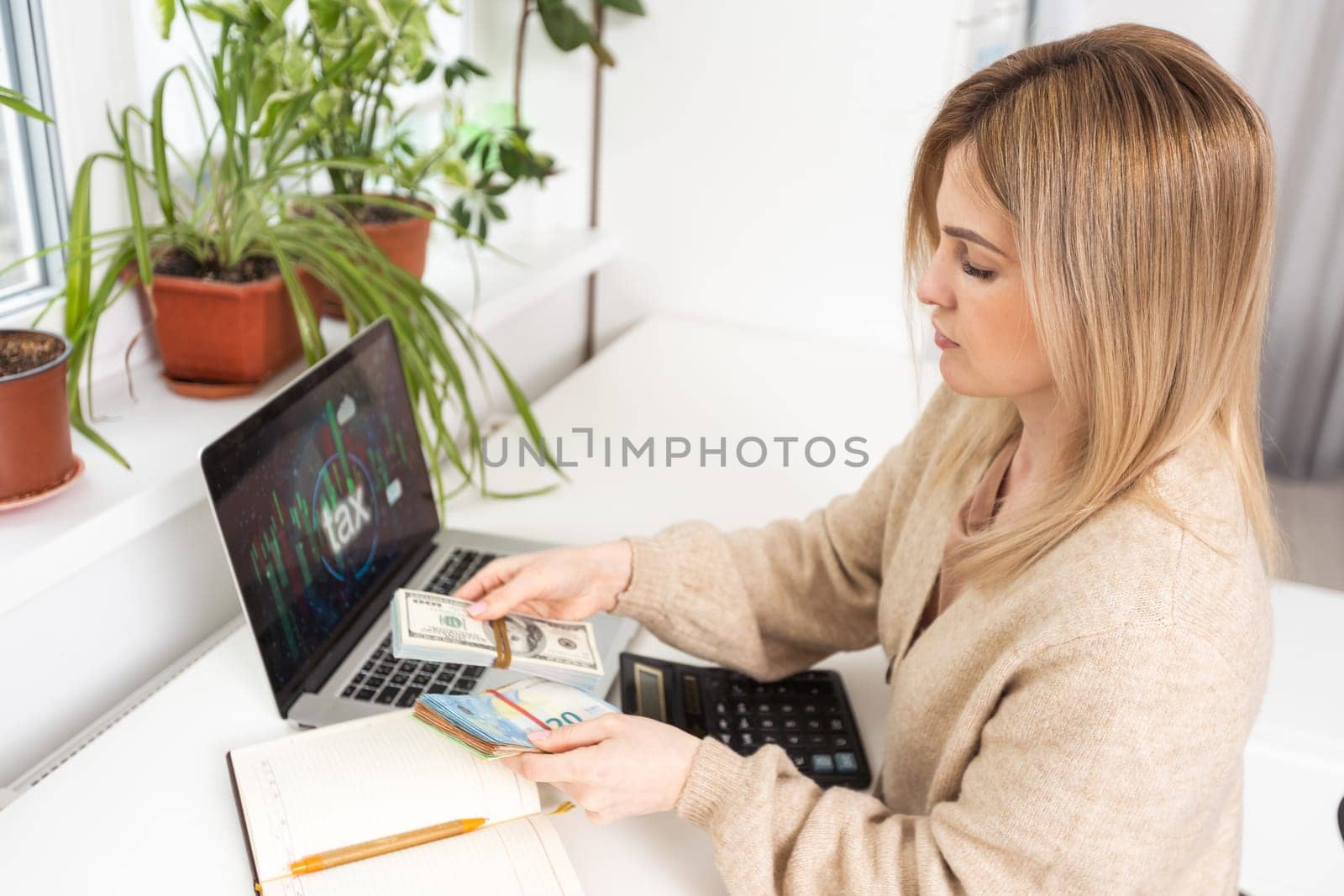 Close up of woman busy paying bills online on computer calculating household finances or taxes on machine, female manage home family expenditures, using calculator, make payment on laptop
