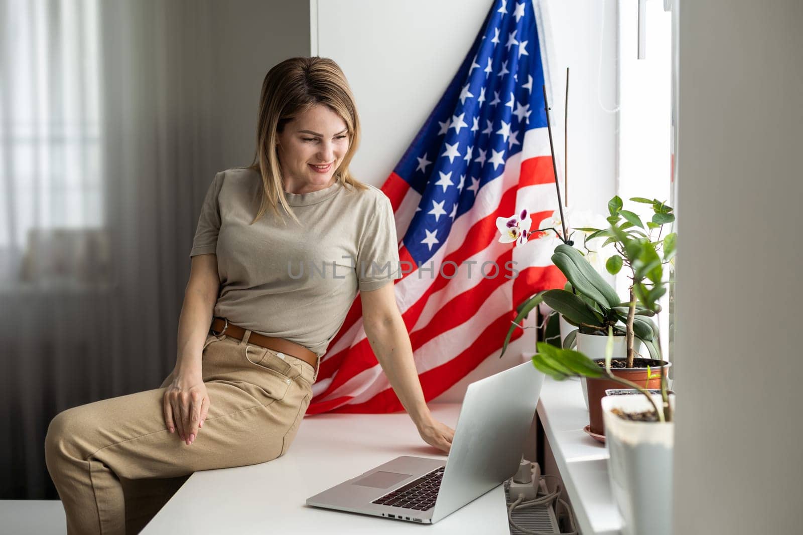 woman with laptop and usa flag. Foreign languages learning, educational online course by Andelov13