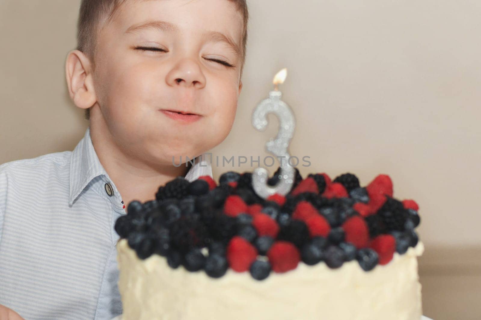 A boy blows out the candles for his birthday