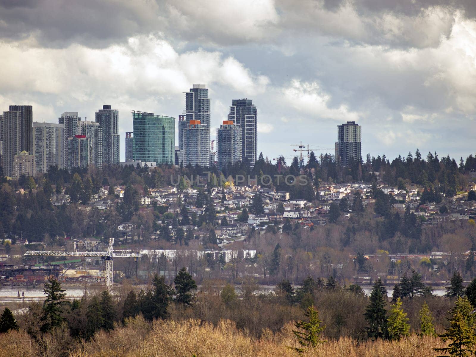 View of central part of Surrey, BC, Canada over Fraser river. Surrey downtown view on cloudy sky background. 07 Apr, 2023.