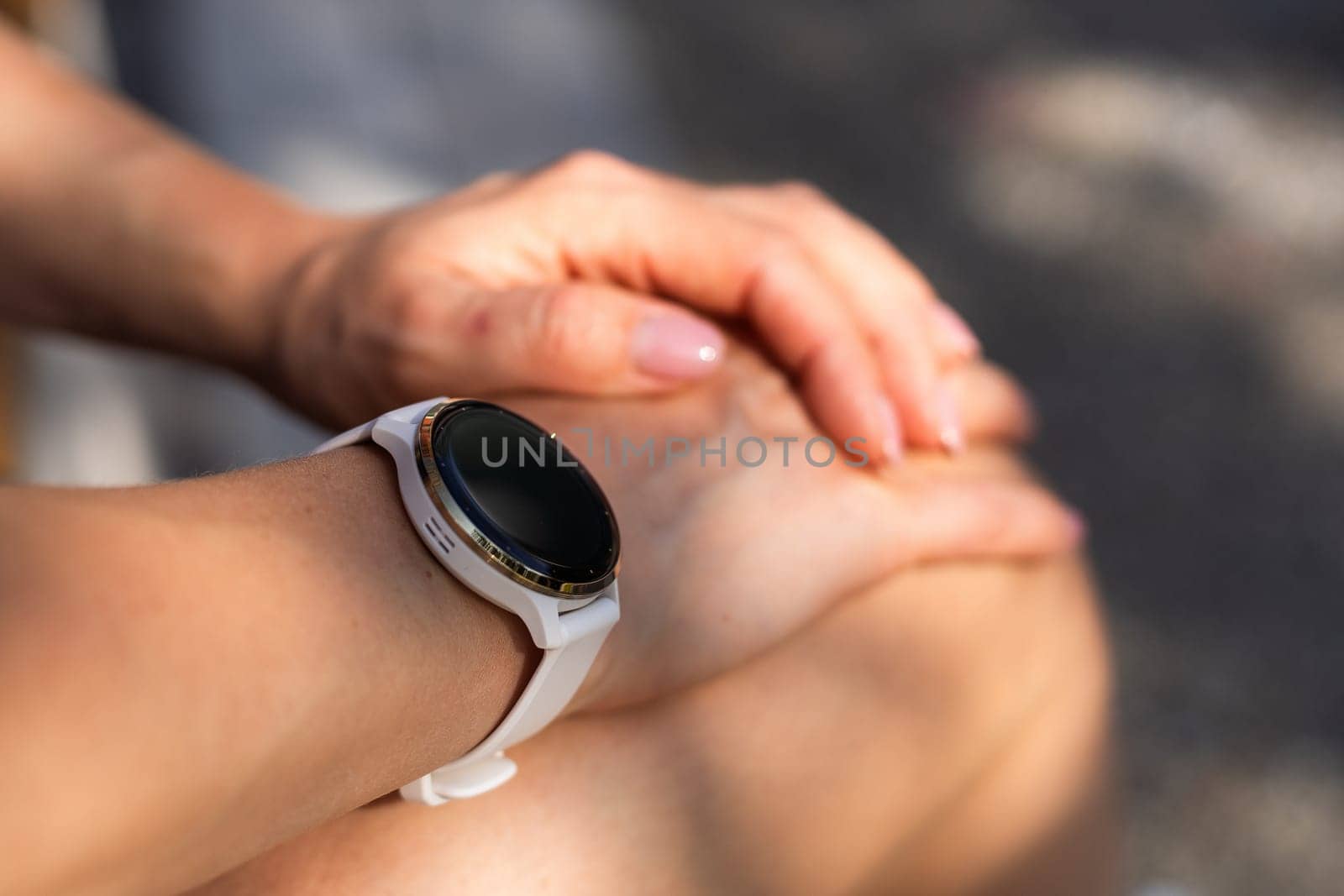 Modern sport gadget concept - young woman using a smartband. High quality photo