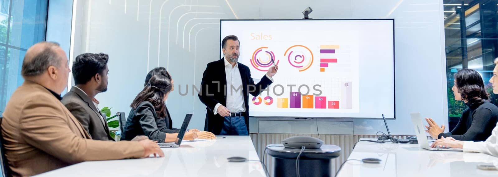 Business manager man present and explain about the progress of the project to his colleagues or staffs in conference or meeting room.