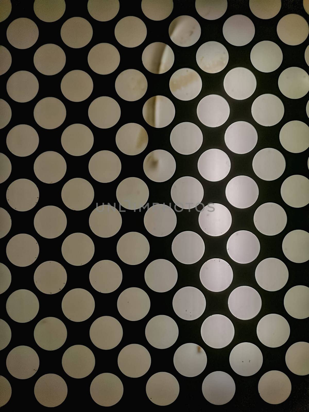 White circles with glowing light on ceiling inside old elevator