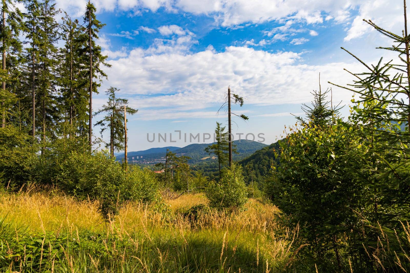 Beautiful landscape of small city and beautiful hills and mountains next to it at sunny day