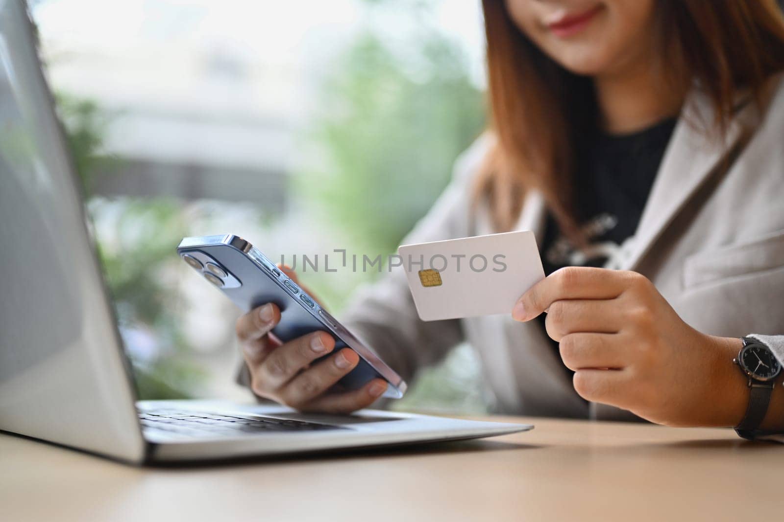 Businessman holding plastic card making online payment purchase or transferring money in ebank app. by prathanchorruangsak