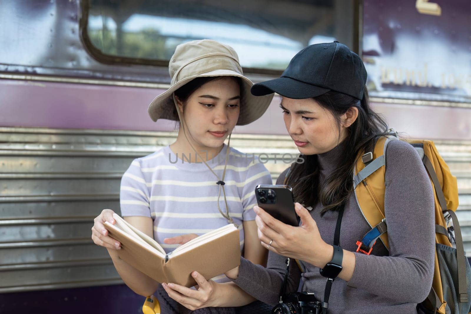 Woman using mobile phone while travel by train. travel concept.