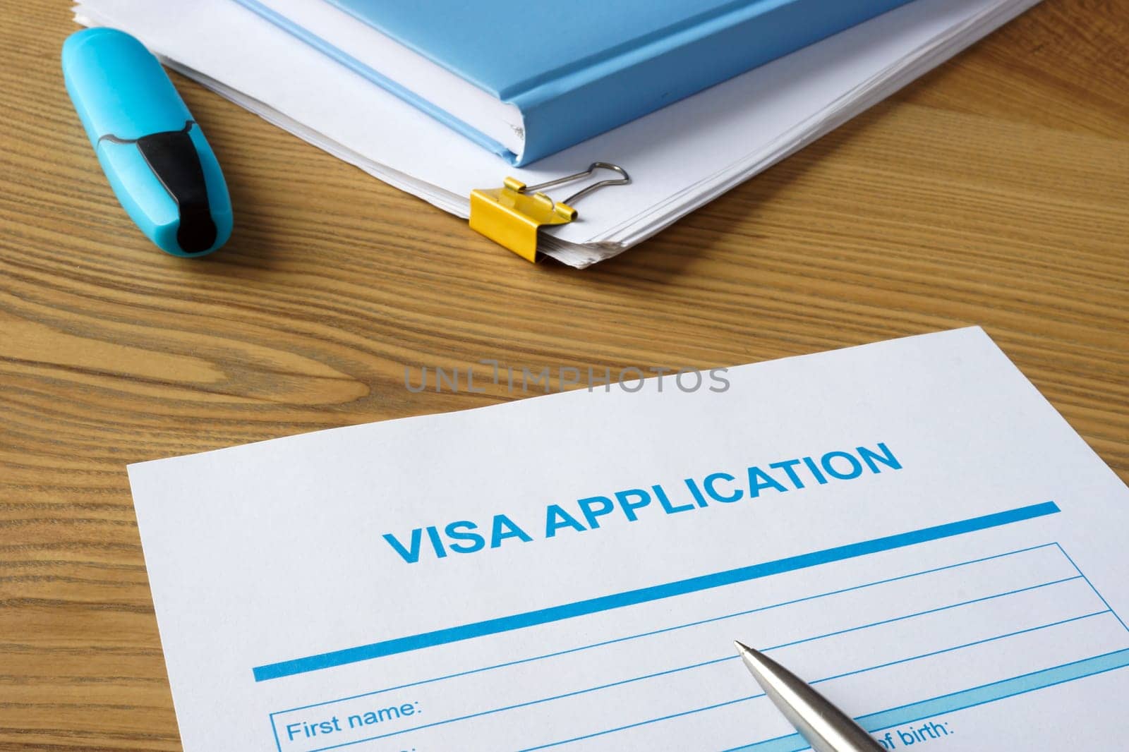 Empty visa application form and a pen.