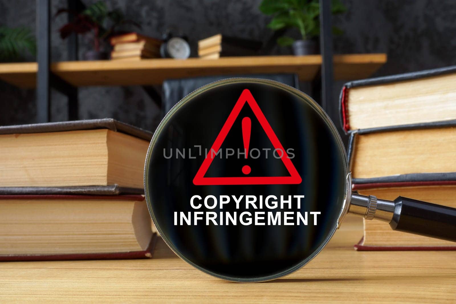 Books and magnifying glass with inscription Copyright infringement. by designer491