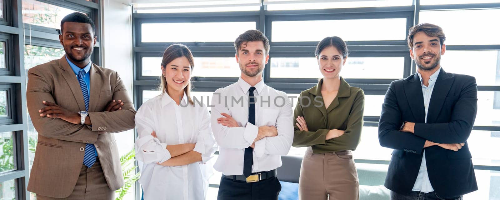 Portrait group of multiethnic business men and women stand in the office and arm crossed action to the camera with smiling. by nrradmin