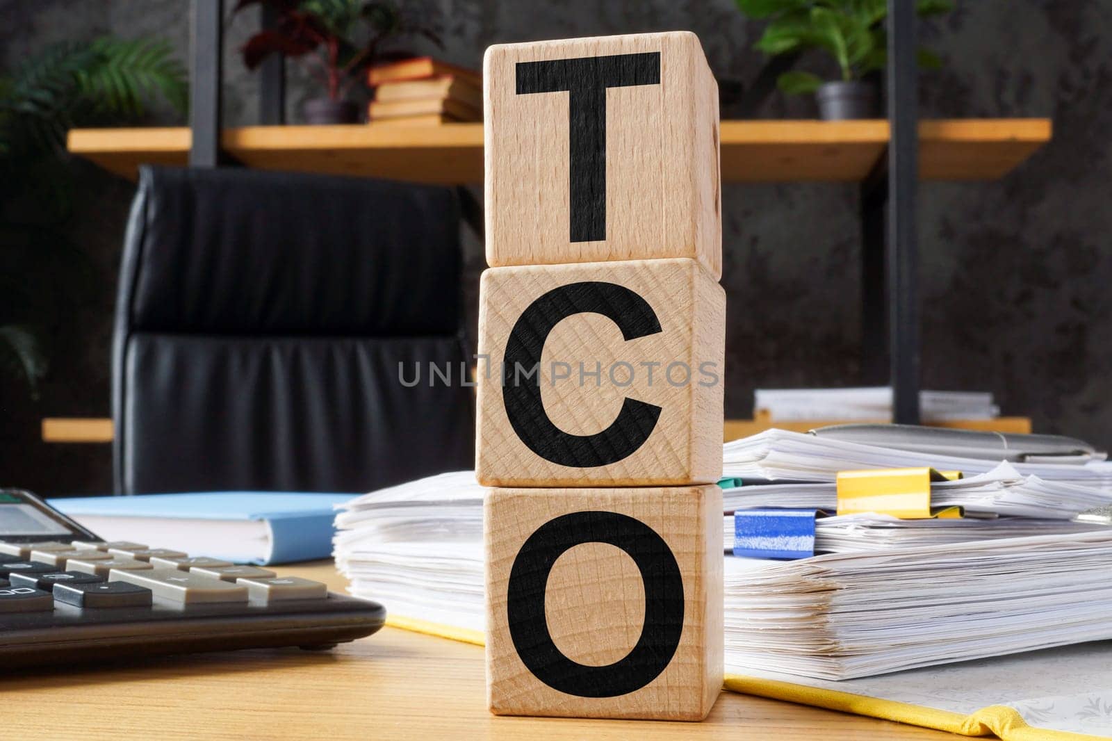 Wooden cubes with abbreviation TCO Total Cost of Ownership.