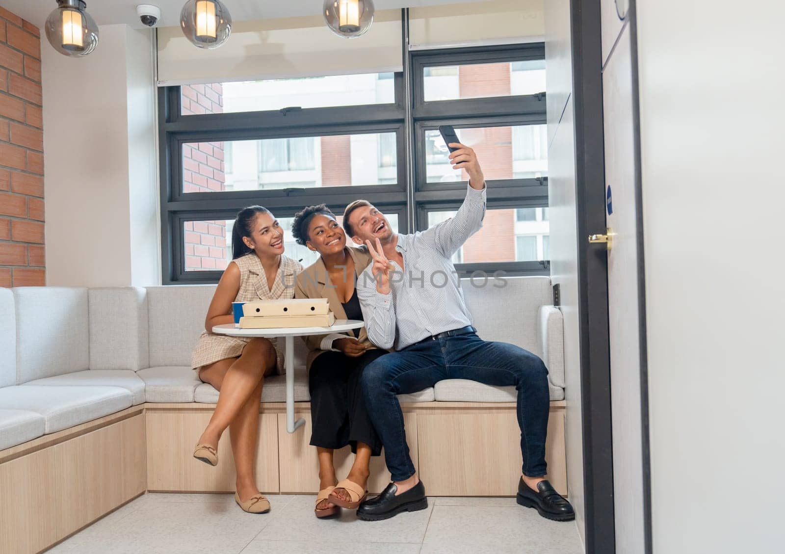 Business man and women enjoy break time also selfie together in the office before have lunch with the pizza.