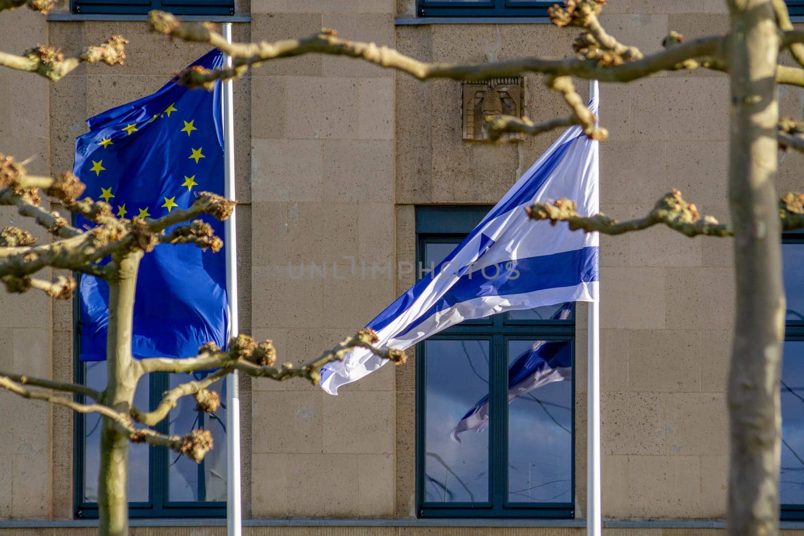 EU and Israeli flags flutter in the wind. High quality photo