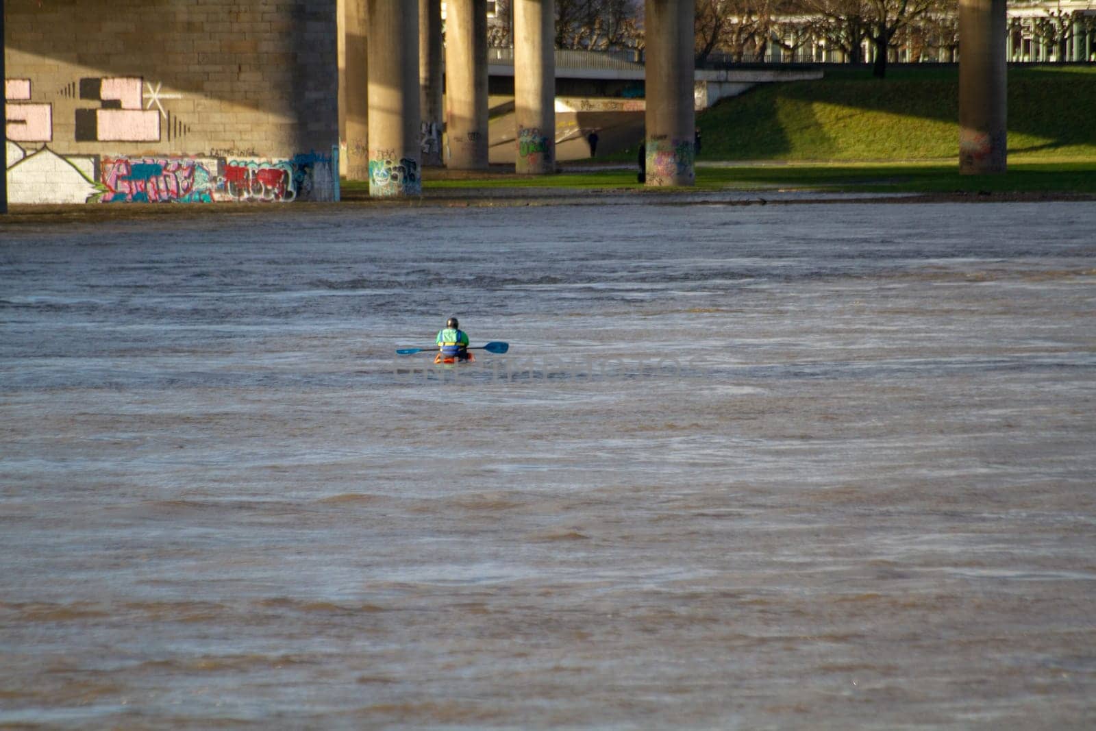 A man kayaks on the Rhine river in Dusseldorf. High quality photo