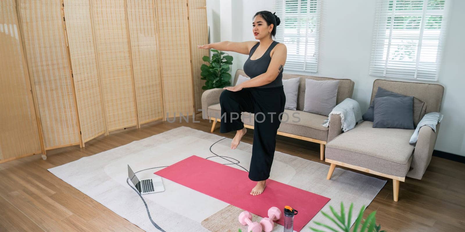 Cheerful attractive young overweight woman in activewear choosing healthy lifestyle.