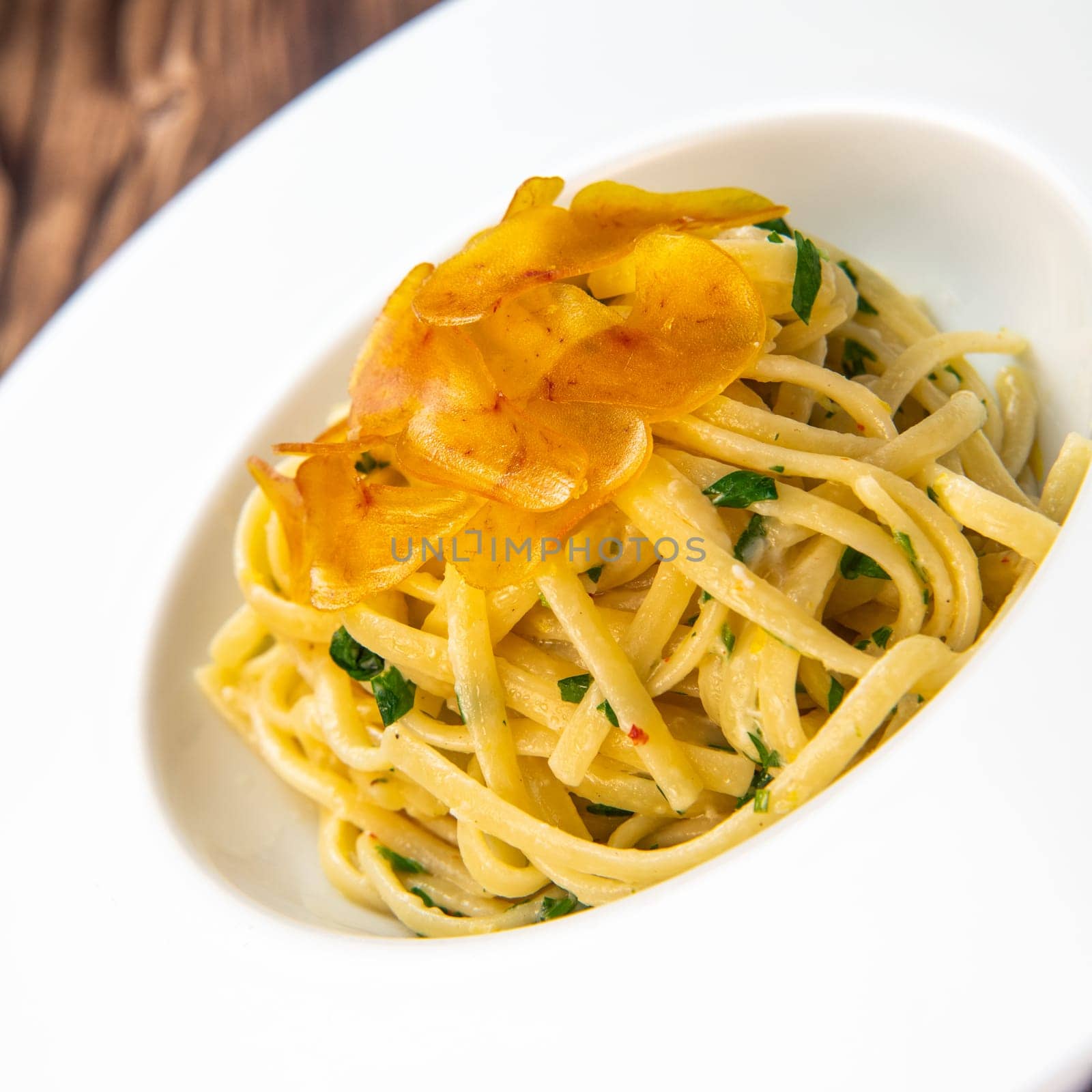 LINGUINE PASTA RECIPE WITH POUTARGUE, LEMON, GARLIC, LEMON ZEST, FRESH CREAM AND PARSLEY. High quality photo